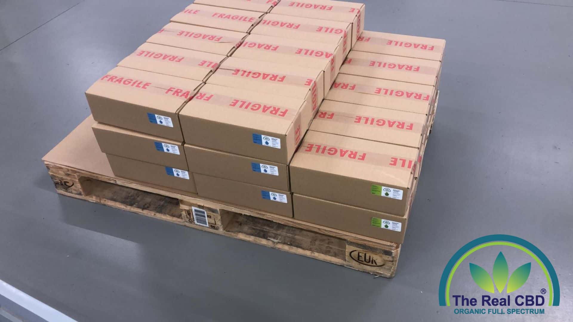 Boxes of The Real CBD oils on a pallet