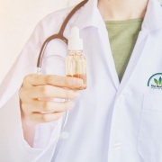 Doctor holding a tincture bottle with oil