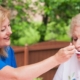 Caretaker feeding an elderly lady