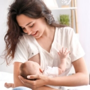 Happy woman breastfeeding her child