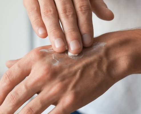 Hand applying crème onto the opposite hand