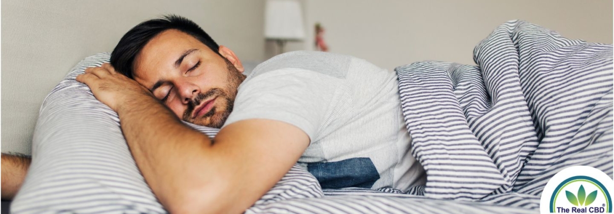 Man sleeping soundly on his stomach in a fresh bed