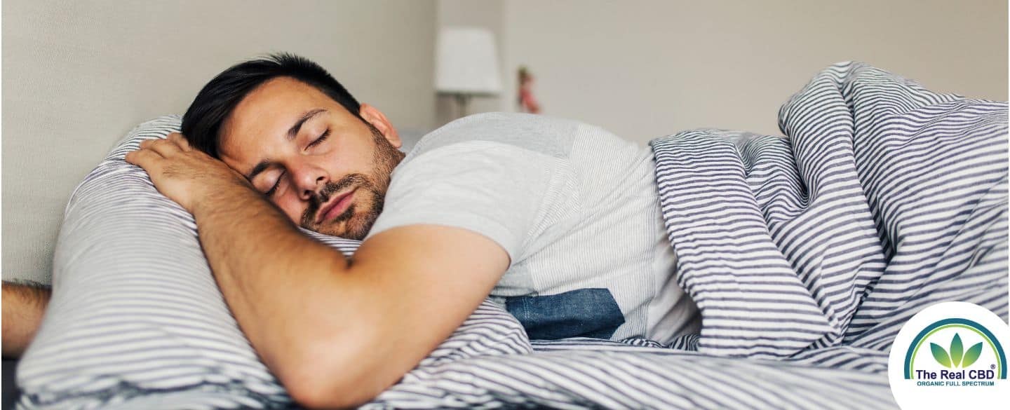 Man sleeping soundly on his stomach in a fresh bed