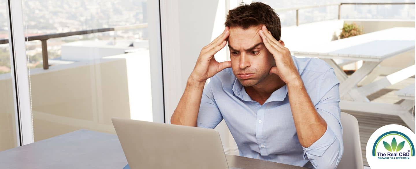 Man looking frustrated at a laptop screen