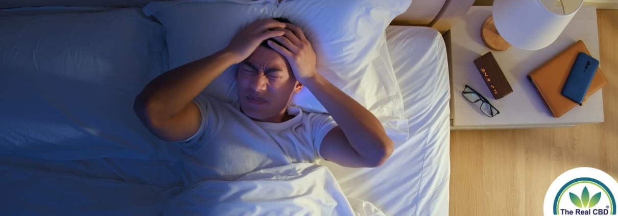 Person in bed at night unable to sleep