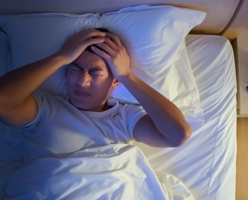 Person in bed at night unable to sleep