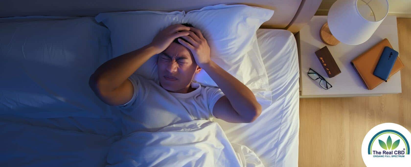 Person in bed at night unable to sleep