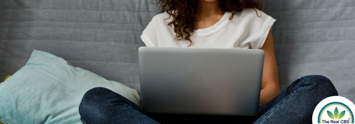 Teen working on a laptop in bed