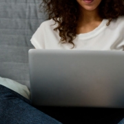 Teen working on a laptop in bed