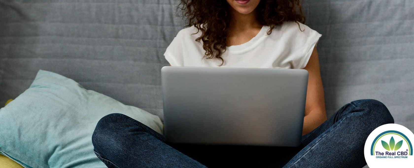 Teen working on a laptop in bed