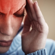 Woman holding her head in pain