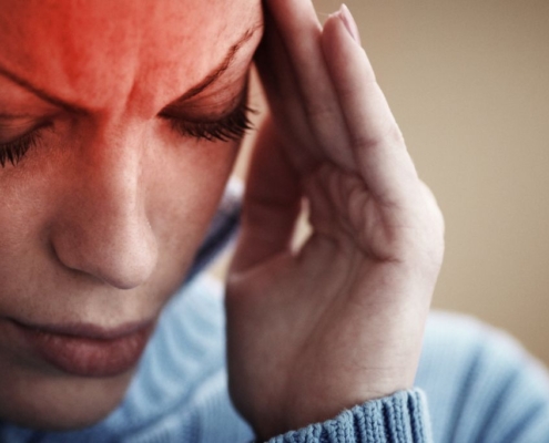 Woman holding her head in pain