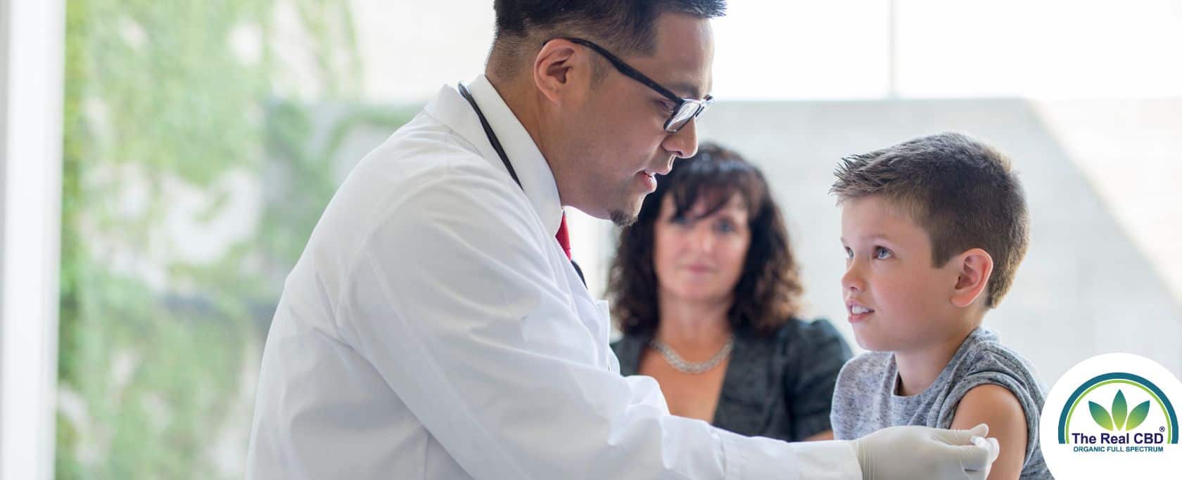 Doctor giving boy a vaccine injection