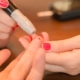 Woman doing a diabetes finger prick on a man