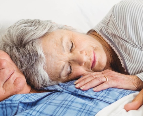 Old couple sleeping together