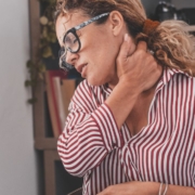 Woman holding her neck in pain