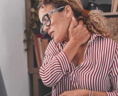 Woman holding her neck in pain