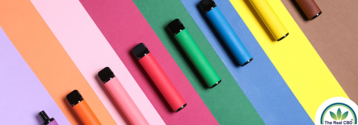 Multicoloured vape pens on a stripy matching background