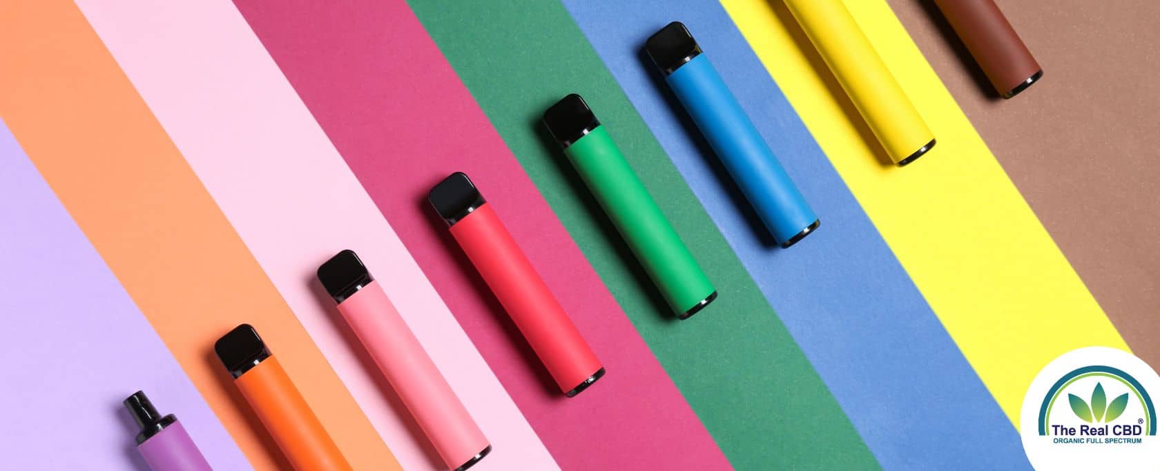 Multicoloured vape pens on a stripy matching background