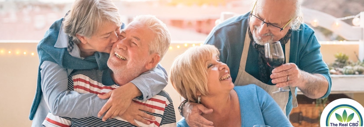 Two middled couples having a good time drinking wine at a BBQ