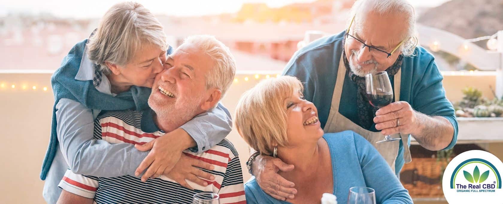 Two middled couples having a good time drinking wine at a BBQ