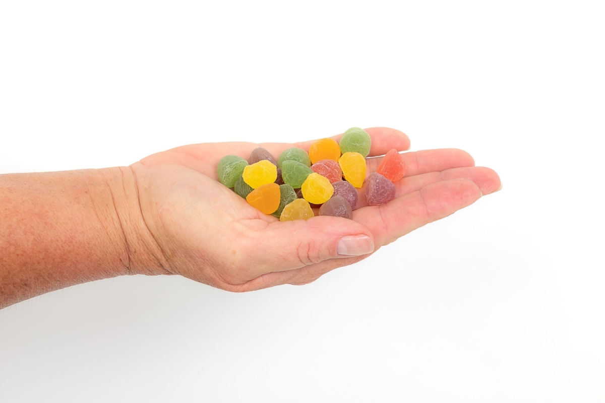 CBD gummies laid out on palm of a hand - The Real CBD Brand