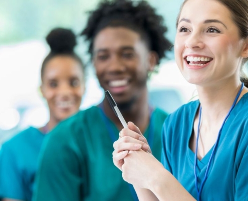 A team of happy nurses in scrubs