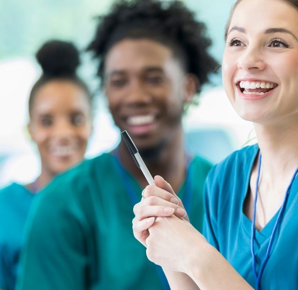 A team of happy nurses in scrubs