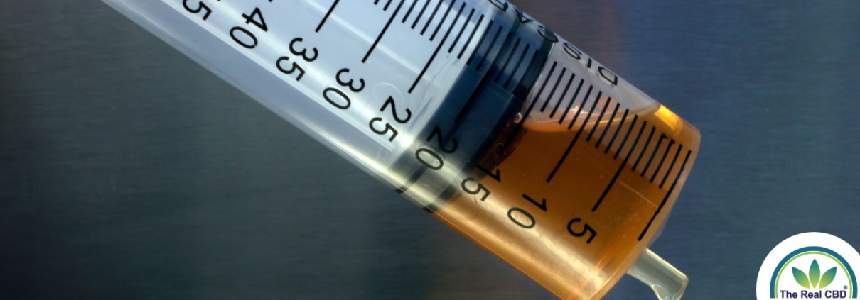 Close-up of brown oil in syringe