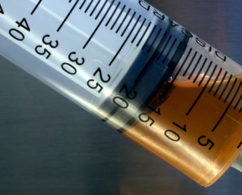 Close-up of brown oil in syringe