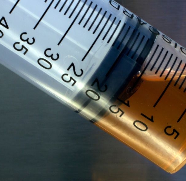 Close-up of brown oil in syringe