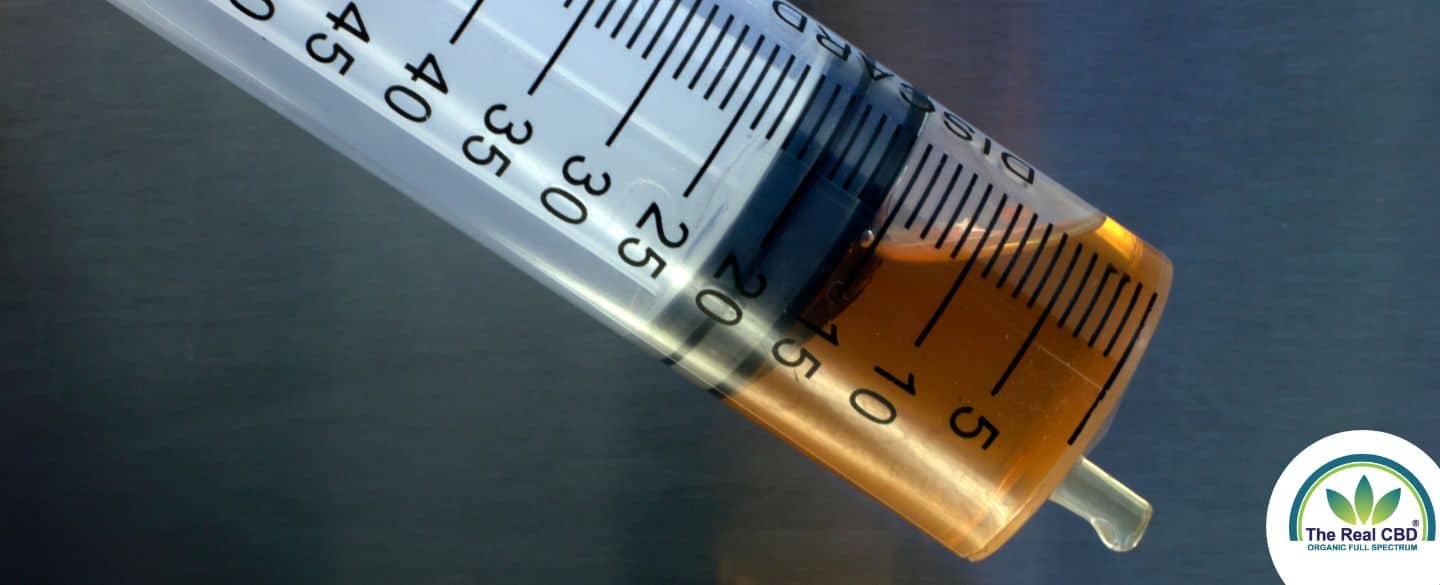 Close-up of brown oil in syringe