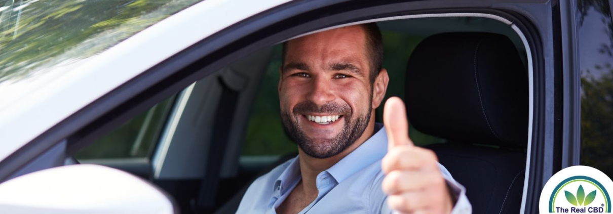 Man gives thumbs up in a car