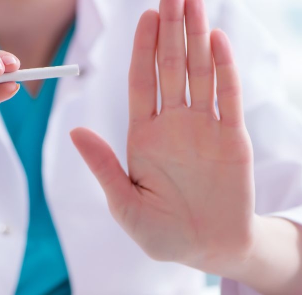 Doctor holding a cigarette asking to stop