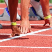 Hands of runners on start line ready to start a race