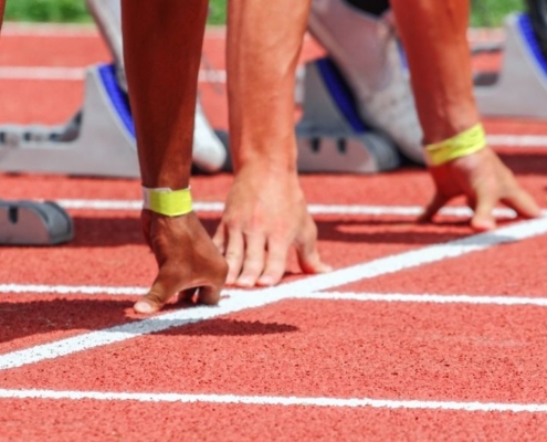 Hände von Läufern an der Startlinie, bereit zum Start eines Rennens