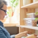 Woman in pantry with produce and CBD oil on the shelf