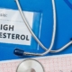 High cholesterol file with capsules and stethoscope