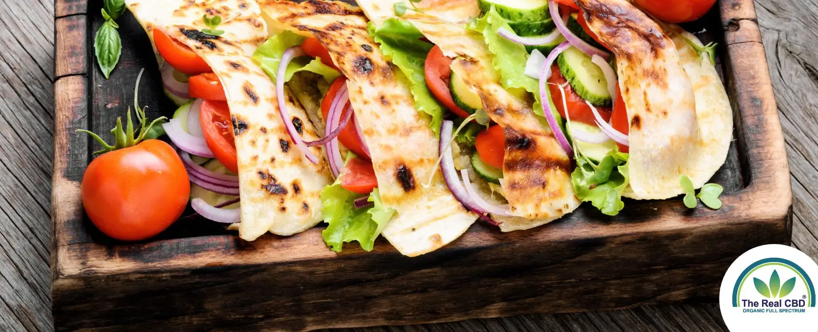 Pita bread sandwiches on a wooden tray