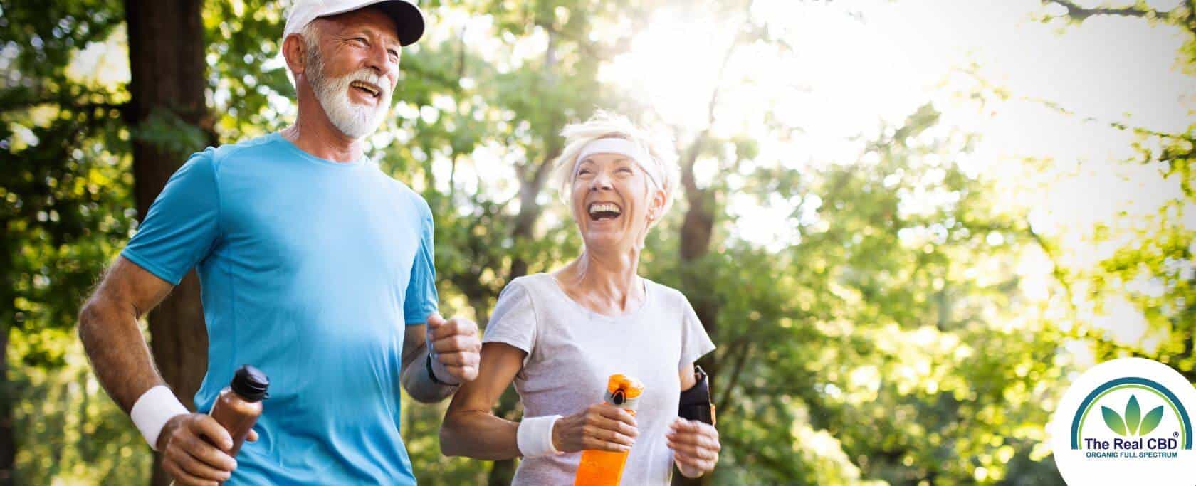 Happy old couple running in the forrest