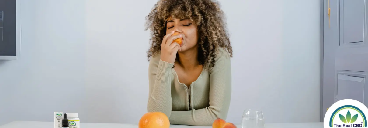 Woman enjoying a peach at a dinner table