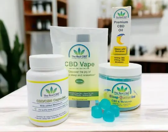 CBD sleep products on a wood table top in a shop - The Real CBD Brand