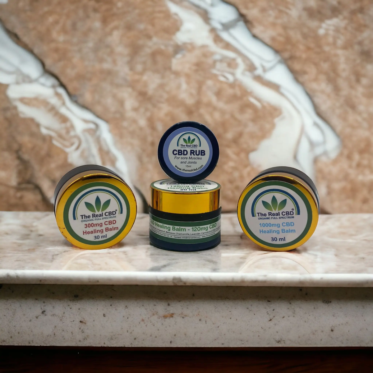 Various CBD balms on marble shelf - The Real CBD Brand