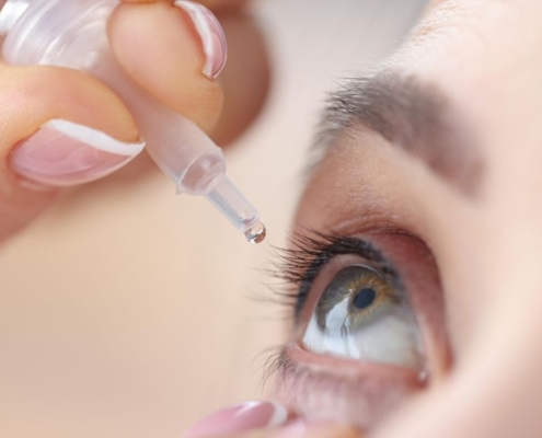 Woman dropping her eye with eye drops