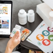 Man holding a tablet with The Real CBD website on and a jar of The Real CBD tablets