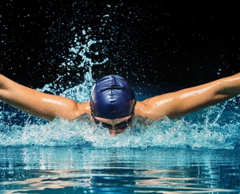 Swimmer in swimmingpool doing butterfly