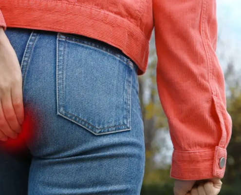 Woman walking up the stairs holding her butt