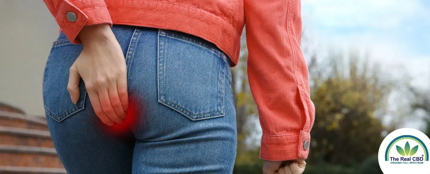 Woman walking up the stairs holding her butt