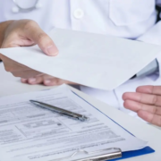 Doctor handing over a prescription to a patient