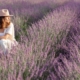 Woman sitting in a lavender field with her dog